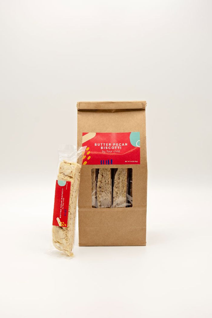 a package of butter pecan biscotti with an individually wrapped one leaning against it