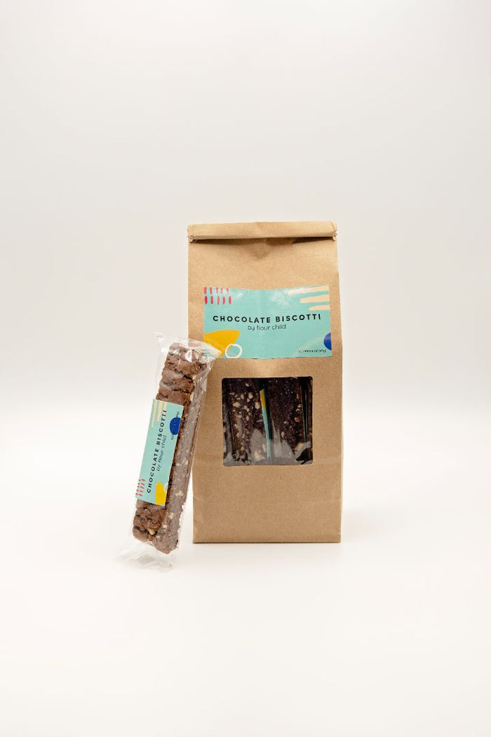 a package of chocolate biscotti with an individually wrapped one leaning against it