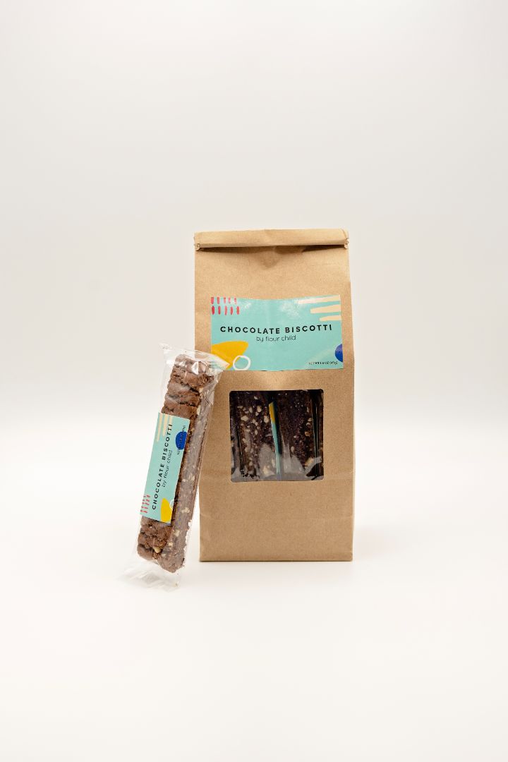 a package of chocolate biscotti with an individually wrapped one leaning against it