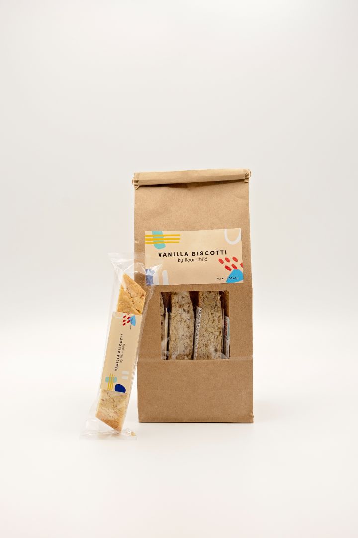 a package of vanilla biscotti with an individually wrapped one leaning against it